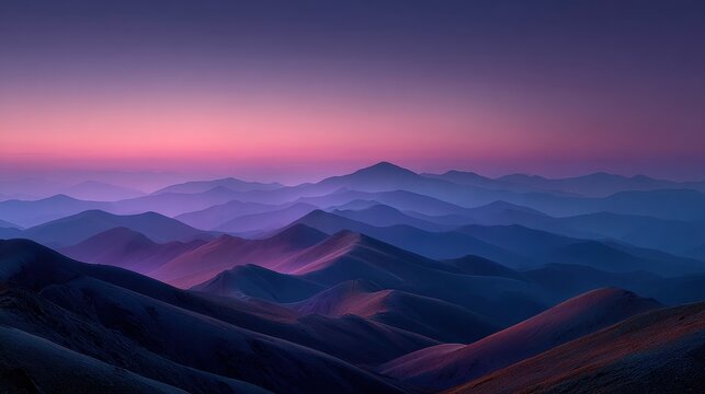 Majestic layers of symmetrical hills are seen under a colorful purple and blue twilight sky, creating a serene and scenic mountain vista