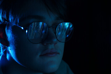 Man wearing glasses with reflection on black background, closeup. Space for text