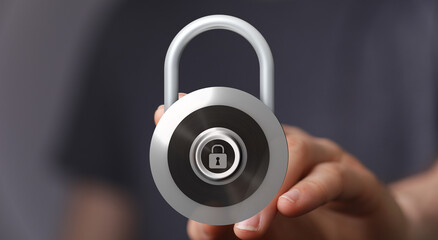 Close-up of a hand holding a silver padlock. Represents data safety, privacy, and digital security. Great for c