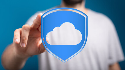 Hand holding a cloud symbol in shield form, representing data protection, security, and safe online...