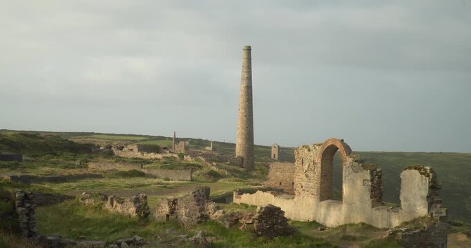 Old stone ruins of engine houses at Botallack mines on the Atlantic coast of Cornwall, England, UK during golden hour at sunrise