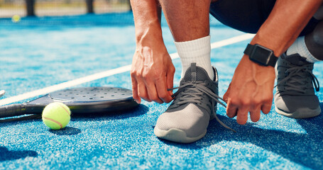 Man, hands and tie shoes on padel court for outdoor match or workout preparation. Wellness, male person and athlete legs getting ready with sneakers, laces and sport for tennis, fitness or challenge