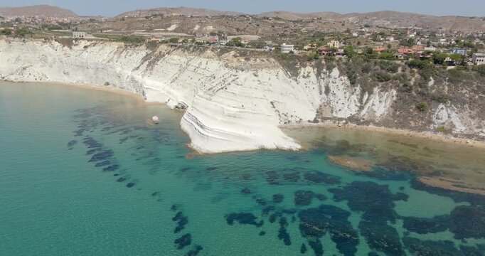 Aerial view of the Scala dei Turchi (Stair of the Turks or Turkish Steps) on the coast of Realmonte, near Agrigento, Sicily, Italy. It's a rocky cliff and tourist attraction. The sea is azure, crystal