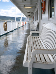 Fototapeta premium Empty ferry deck with benches overlooking the ocean