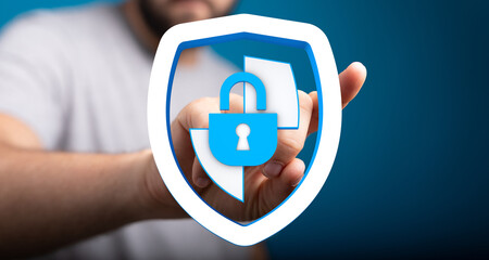 Hand holding a shield with a lock, representing data security, privacy, protection, and online...