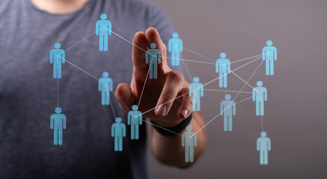 Person interacting with a virtual network of human icons, symbolizing teamwork, and global connections in the d
