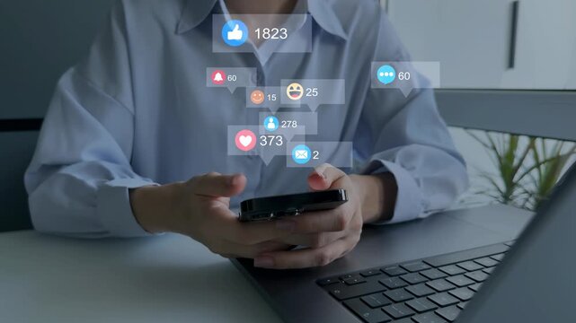 Woman using smart phone with emoticon icons of Social Media.Interactive with friends on chat with emoticon feedback.Social media,marketing, like,social network,blog,live,chat reaction and livestream.