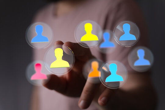 Concept of digital human connections and networking through hand touching virtual icons, representing people and communication.