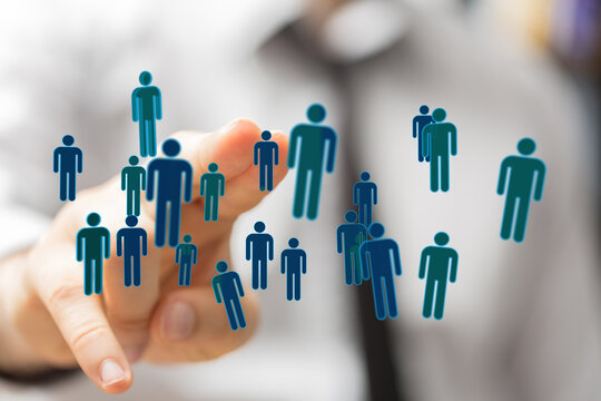 Concept of teamwork, community, and social interaction, with a hand pointing towards icons of people representi