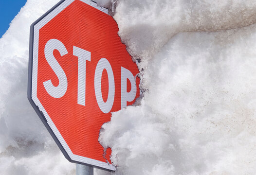 stop sign covered with iced snow