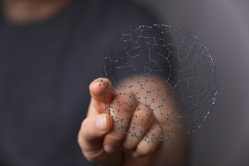 Close up shot of a hand holding a glowing digital network sphere, representing global connection,...