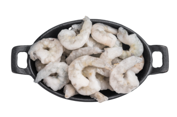 Top view of icy uncooked shellfish (shrimp) in a small black skillet. Protein-rich, healthy ingredient for quick dinner recipes.