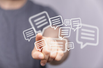 Obraz premium Concept of digital communication. Finger touching digital speech bubbles, messaging, chatting, and social media ideas.