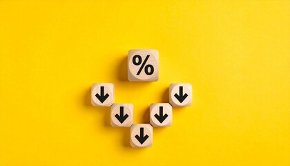 Wooden blocks with percent and downward arrows on yellow