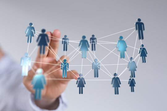 Hand touching network of people icons, representing social connections, communication, community, and business