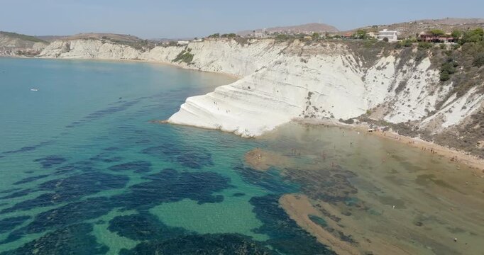 Aerial view of the Scala dei Turchi (Stair of the Turks or Turkish Steps) on coast of Sicily, Italy. It's a rocky cliff formed by marl, a sedimentary rock with white color. It overlooks turquoise sea.