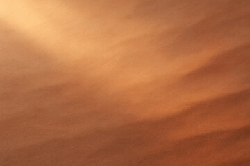 Warm tan nature inspired backdrop with suede-like texture and soft brushed patterns. Depth and movement with soft light streaks. Matte surface with subtle natural variations.