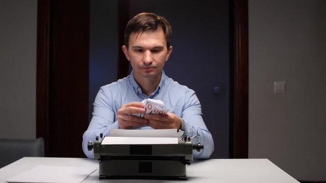 Man holding a fan of dollar bills, sitting at a desk with a vintage typewriter and blank paper, symbolizing the concept of making income from creative writing and traditional work