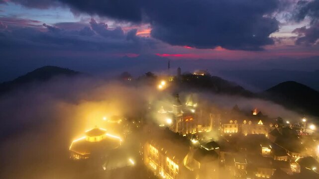Aerial view of Ba Na Hills at night, cable car ride to see French Village, Debay Wine Cellar, Linh Phong Zen Monastery, Fantasy Park, Golden Bridge. Ba Na Hills is located in Da Nang, Vietnam.