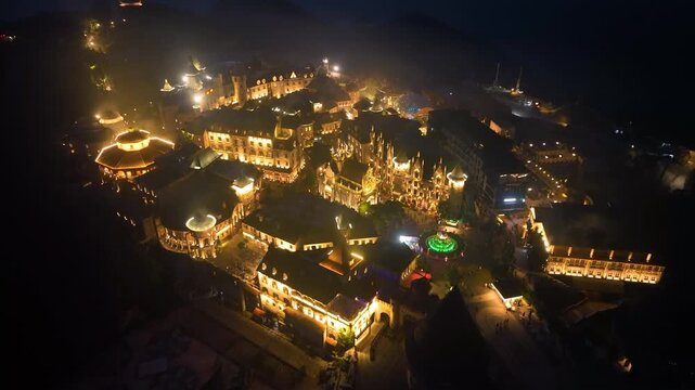 Aerial view of Ba Na Hills at night, cable car ride to see French Village, Debay Wine Cellar, Linh Phong Zen Monastery, Fantasy Park, Golden Bridge. Ba Na Hills is located in Da Nang, Vietnam.
