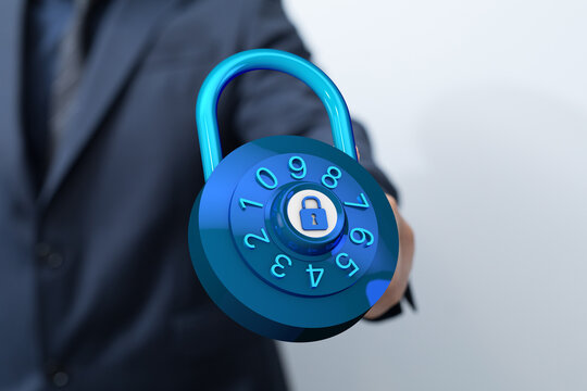 A close-up shot of a business person holding a digital combination lock. Symbolizing data security and protecti