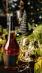 Festive table setting with whiskey, decorations, and warm lights