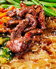 Delicious beef stir-fry served with vegetables and noodles on a vibrant plate
