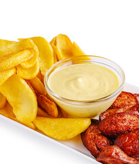 Delicious platter of crispy potatoes and savory sausage with dip