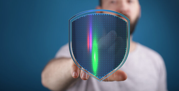 A man's hand holds up a digital shield, representing data protection, cyber security, and online safety in a modern, technological co - Powered by Adobe