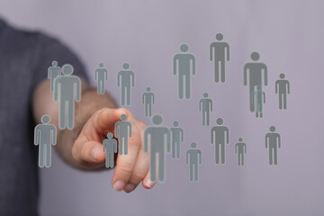 Hand pointing at floating digital people icons, teamwork concept, connection, networking. Concept of human reso