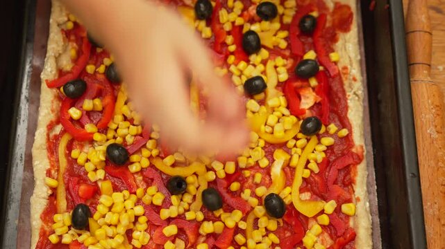 Pizza making, cooking food, adding toppings to vibrant homemade vegetable pizza - Powered by Adobe