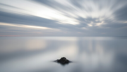 A peaceful misty sunrise over a calm lake with the reflection of a small boat, creating a tranquil and serene atmosphere perfect for nature, meditation, and peaceful journey visuals.