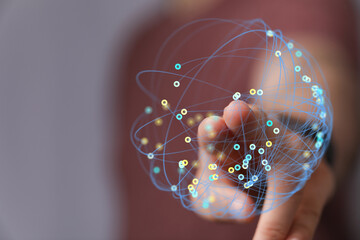 Hand touching a digital network sphere concept. Representing global connection, internet, digital data, and worldwide access to information.