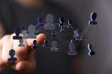 Hand pointing at a digital network of people, representing connection and teamwork, concept of social media and
