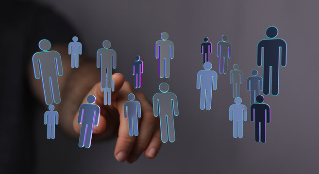 Hand pointing at glowing people icons symbolizing teamwork, unity, and business network connections. Digital co
