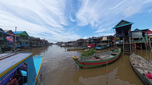 Traditional boat cruising through Kampong Phluk floating village on Tonl&eacute; Sap Lake, Cambodia