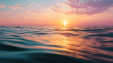Obraz premium Tranquil sunset over calm ocean waves, pastel sky reflecting on water surface.