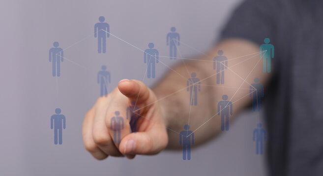 Hand pointing towards digital human network, representing connection, communication, social media, and teamwork