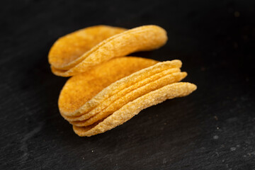 a large number of delicious salty sweet pepper-flavored chips with aromatic spices, close up