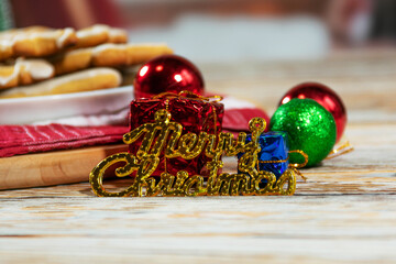 Christmas decorations and cookies on wooden table
