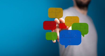 Conceptual image showing speech bubbles made of puzzle pieces representing dialogue, integration, or problem solving communication.