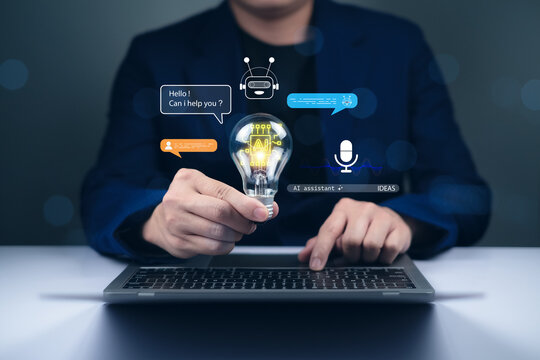 Businessman using laptop holding glowing AI bulb showing artificial intelligence assistant, chatbot communication, and innovation technology concept for smart digital business and future ideas.