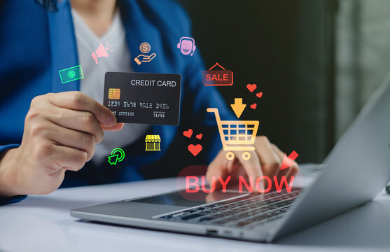 Businessman holding a credit card for online shopping with laptop and digital icons, illustrating e-commerce, digital payment, and internet transaction in a modern shopping experience