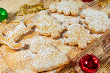 Christmas cookies and ornaments on wooden surface