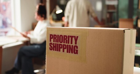 Priority shipping, box label and ecommerce office for expedited parcel, supply chain or logistics. Package sticker, cardboard and special delivery service for distribution, team and business people