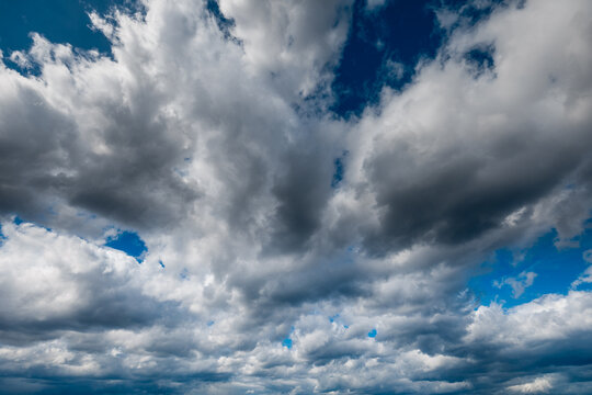 The dark sky with heavy clouds converging and a violent storm before the rain.Bad or moody weather sky and environment. carbon dioxide emissions, greenhouse effect, global warming, climate change.