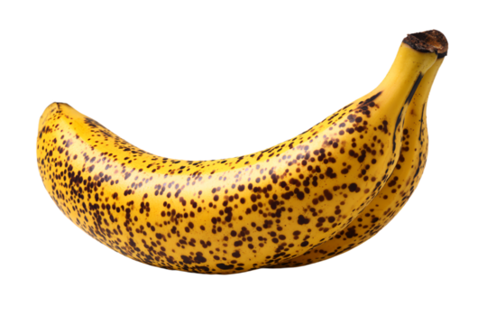 a banana with spots on it sitting on a white surface