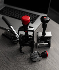 Stamps and embossing tool on desk - concept of stamp production