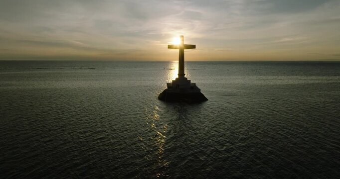 Sunset background on large cross of Sunken Cemetery in Camiguin Island. Philippines.