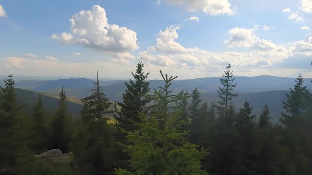 View from Medvedi vrch hill in Jeseniky mountains in Czech republic during partly cloudy springtime day